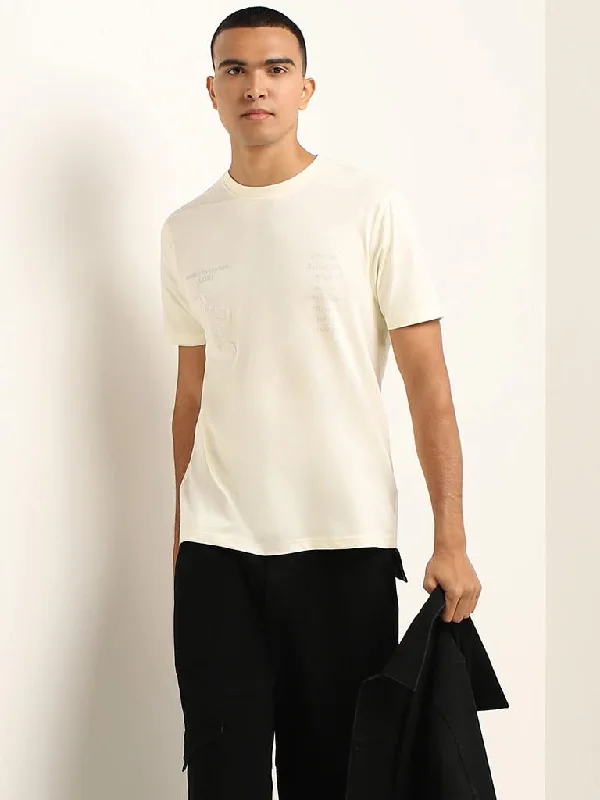 Women's pants for cocktail parties Distressed women jeans for a trendy and edgy look Nuon Cream Printed Cotton Slim Fit T-Shirt Women's pants for cocktail parties Distressed women jeans for a trendy and edgy look Nuon Cream Printed Cotton Slim Fit T-Shirt
